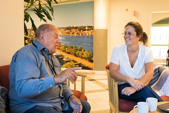 Bengt och Emma sitter i fåtöljer och pratar med varandra